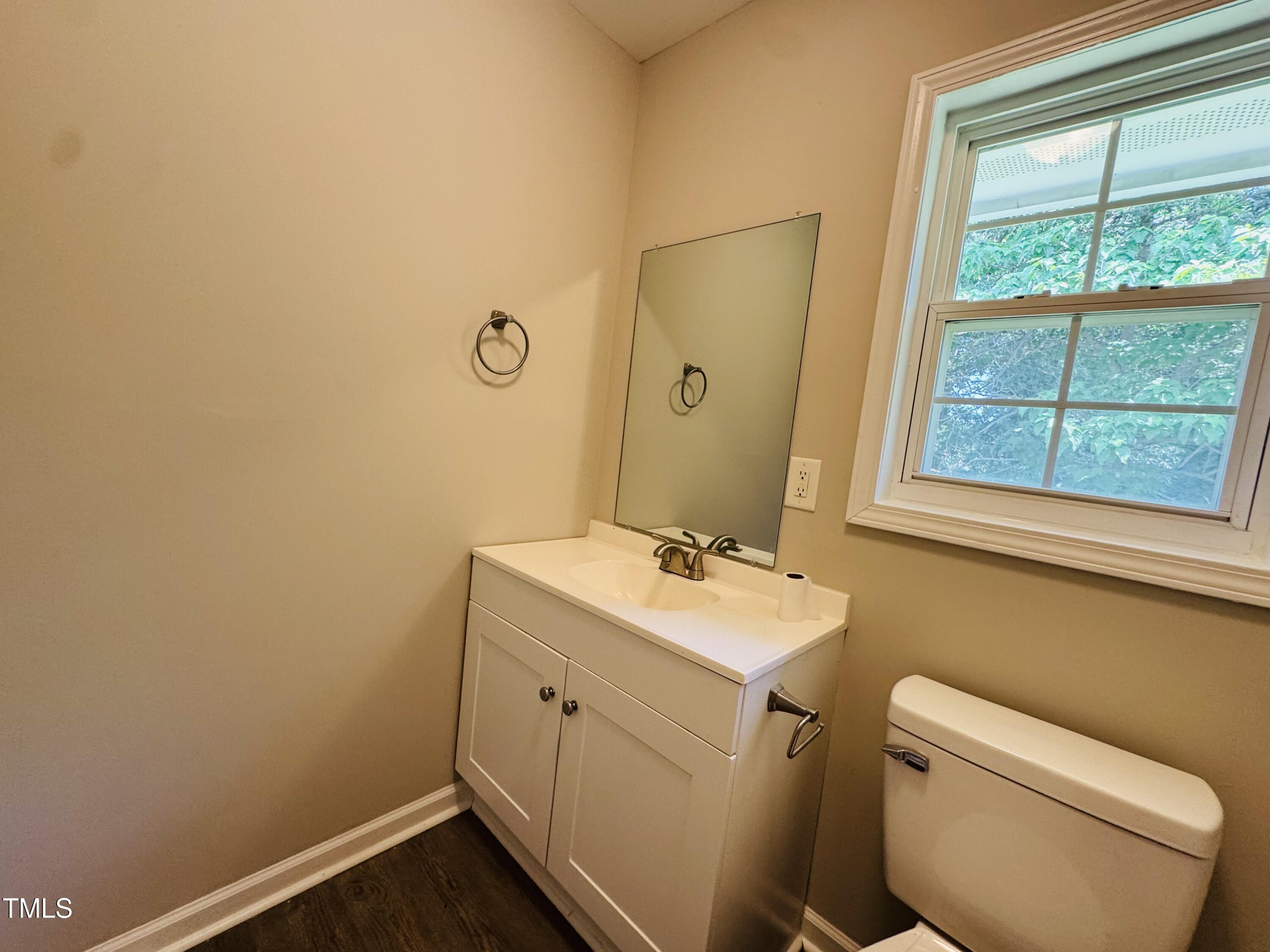 527 Forrest Street Hillsborough, NC 27278 - Photo 31 of 44 a bathroom with a toilet sink vanity and mirror