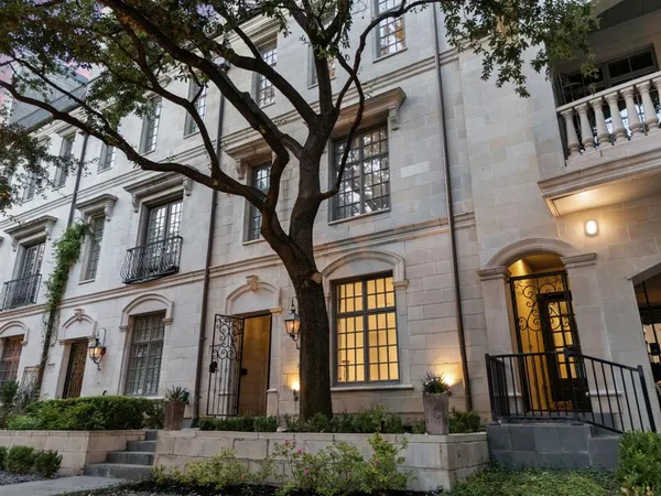 a front view of a residential apartment building with a yard