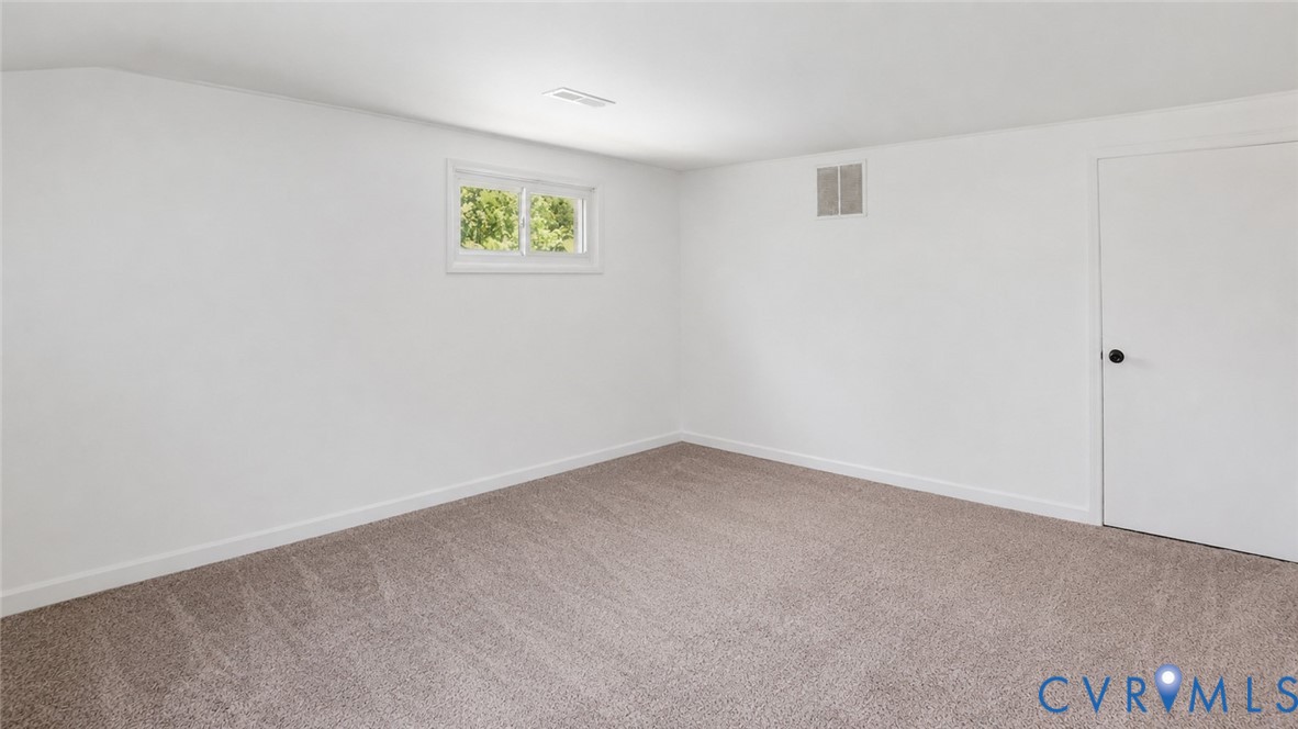 1310 Andover Road Henrico, VA 23229 - Photo 27 of 43 Neutral tone wall color with a window, white trim,