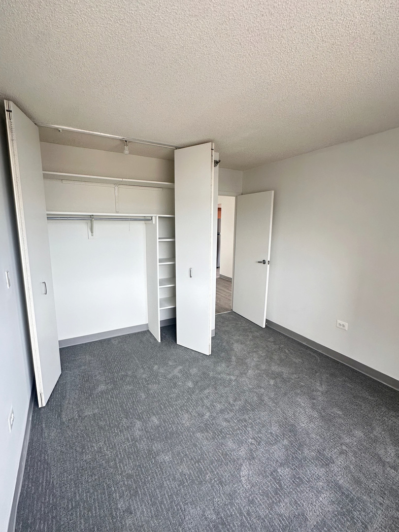 8975 West Golf Road, Unit 321 Niles, IL 60714 - Photo 6 of 10 an empty room with a empty space