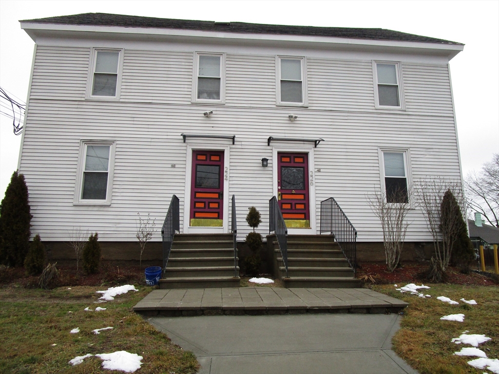 226 Irving Street, Unit 2 Framingham, MA 01702 - Photo 1 of 10 a front view of a house with a yard