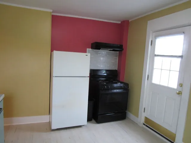 a kitchen with a refrigerator and a stove