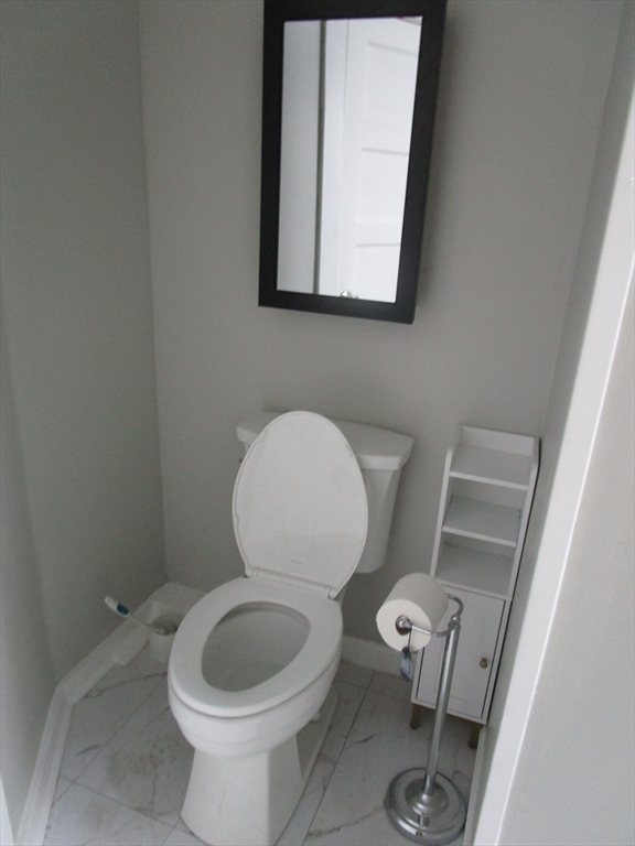 226 Irving Street, Unit 2 Framingham, MA 01702 - Photo 4 of 10 a white toilet sitting next to a bathroom sink
