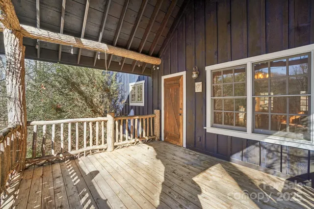 a balcony with wooden floor outdoor seating and yard