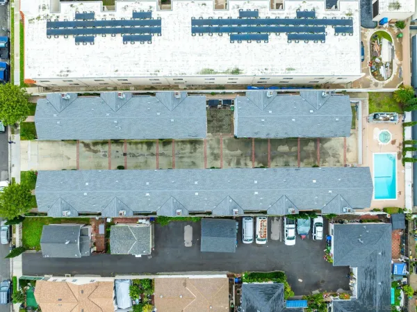 an aerial view of residential houses with outdoor space
