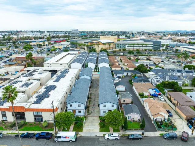 an aerial view of residential houses with outdoor space