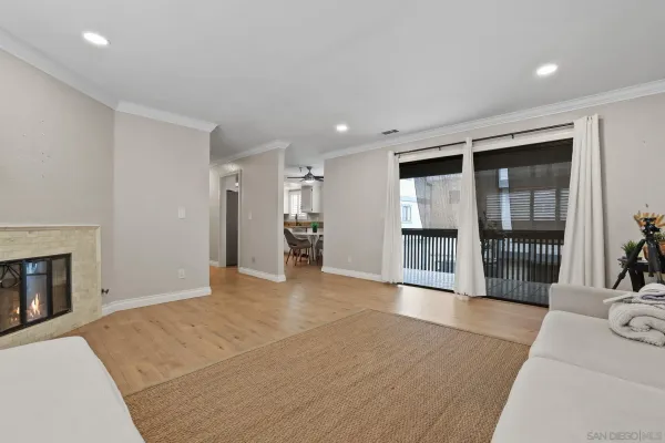 a big room with wooden floor and a fireplace