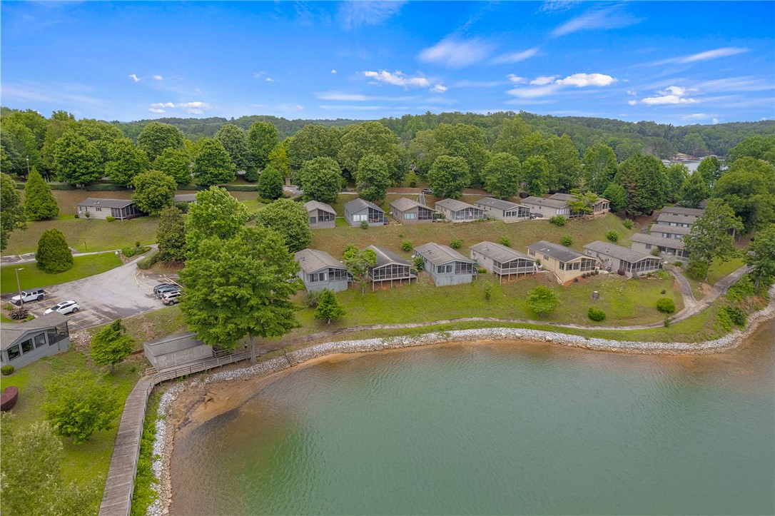1230 Melton Road, Unit 25 West Union, SC 29696 - Photo 35 of 46 Lakeside community with multiple cottages nestled amongst verdant trees, offering serene water views.