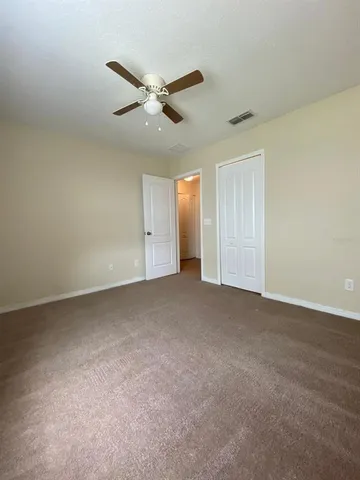 an empty room with wooden floor and entrance