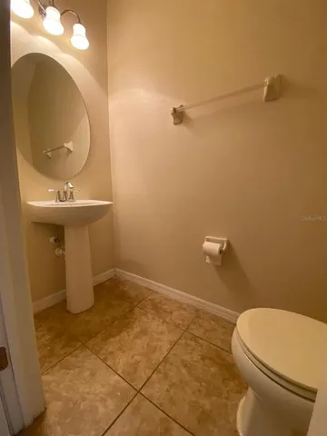 a spacious bathroom with a bathtub shower sink mirror vanity and toilet