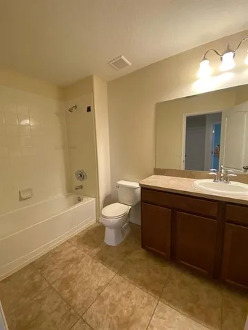 a bathroom with a double vanity sink toilet and shower