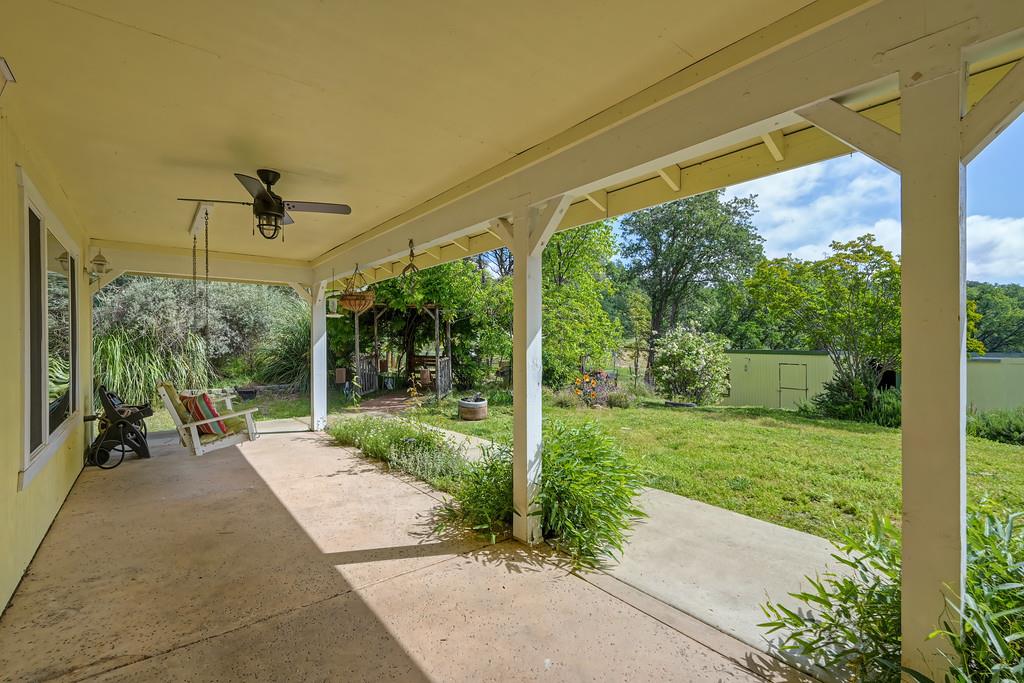6181 Lambert Lane El Dorado, CA 95623 - Photo 13 of 80 a view of a patio with table and chairs under an umbrella