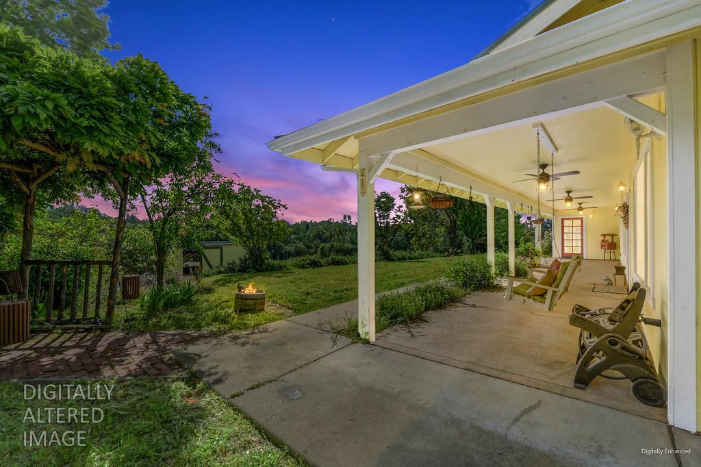 6181 Lambert Lane El Dorado, CA 95623 - Photo 14 of 80 a view of a patio with table and chairs potted plants with wooden floor and fence