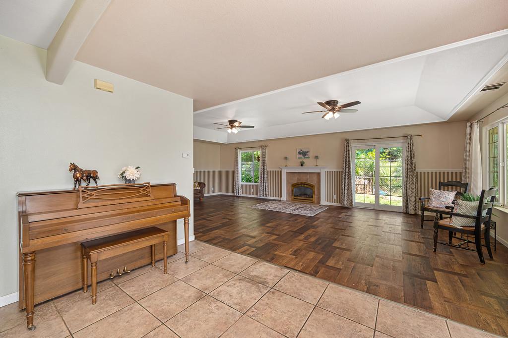 6181 Lambert Lane El Dorado, CA 95623 - Photo 19 of 80 tiled living area with a ceiling fan and a tile fireplace