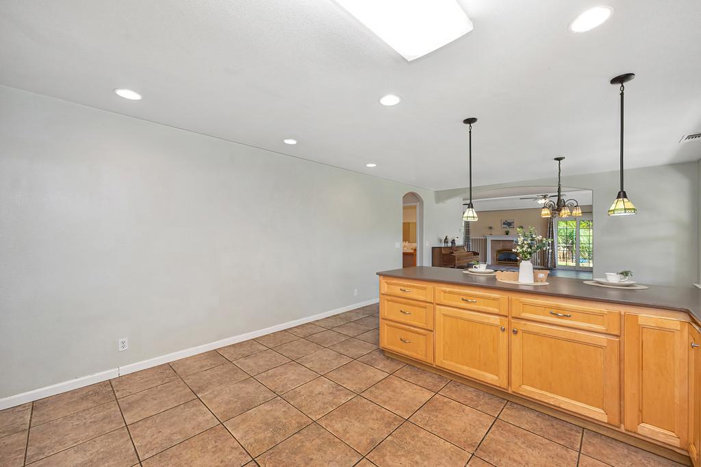6181 Lambert Lane El Dorado, CA 95623 - Photo 78 of 80 a kitchen with stainless steel appliances granite countertop a sink a stove a dining table and chairs