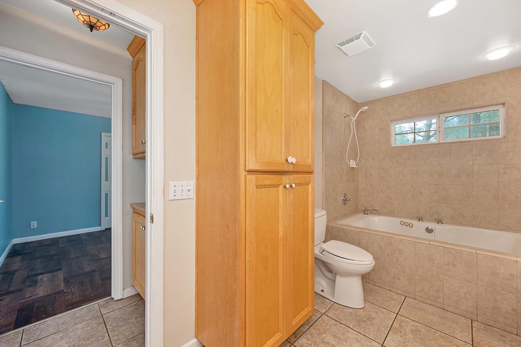 6181 Lambert Lane El Dorado, CA 95623 - Photo 36 of 80 full bath featuring light tile patterned floors, tiled shower / bath combo, and vanity