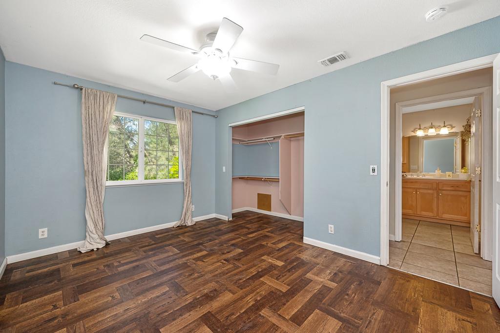 6181 Lambert Lane El Dorado, CA 95623 - Photo 39 of 80 a view of empty room with wooden floor and fan