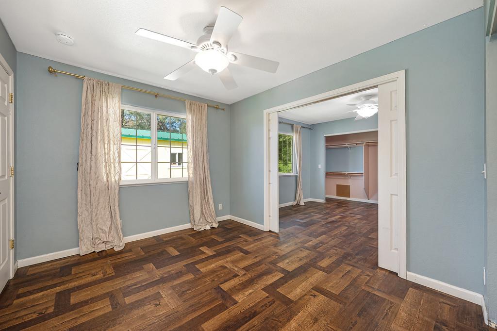 6181 Lambert Lane El Dorado, CA 95623 - Photo 44 of 80 empty room featuring ceiling fan and dark wood-style flooring