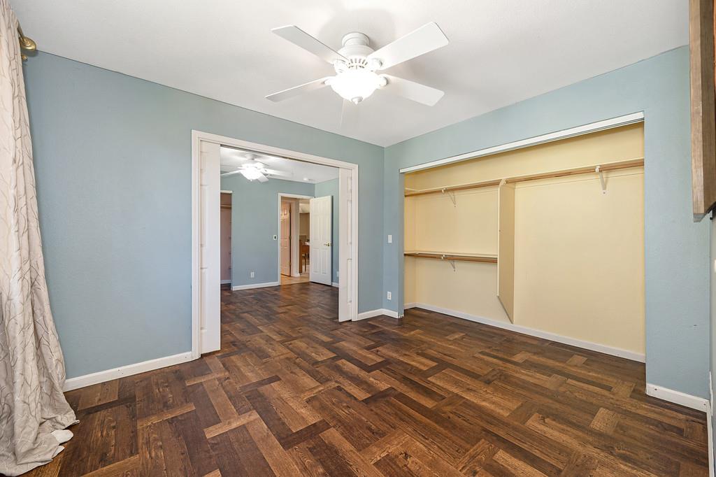 6181 Lambert Lane El Dorado, CA 95623 - Photo 45 of 80 unfurnished bedroom featuring parquet flooring, a ceiling fan, and a closet