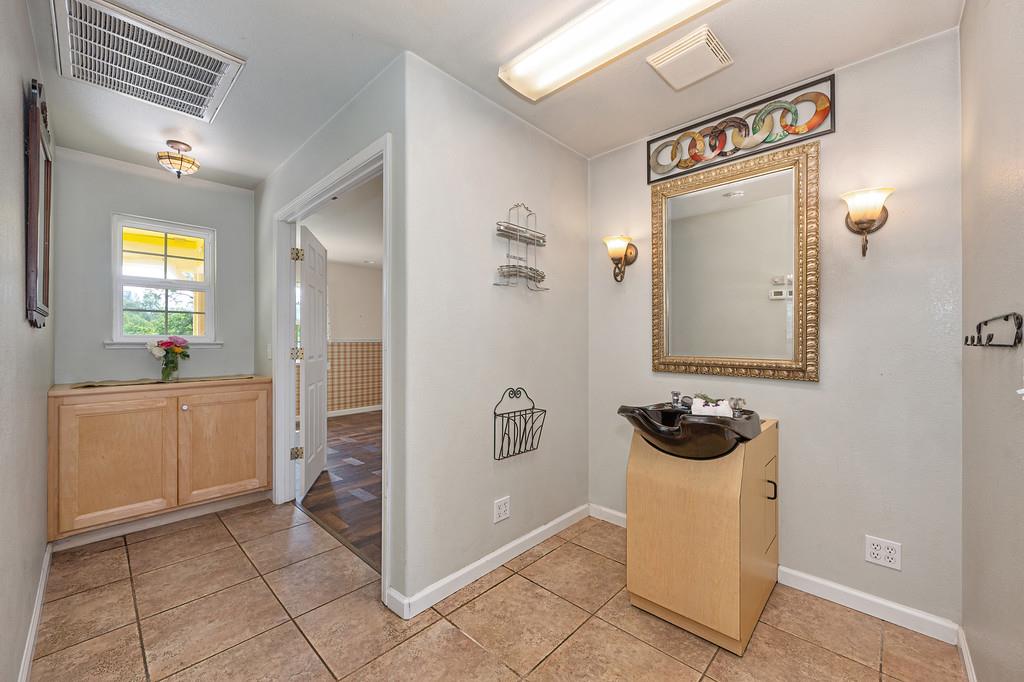 6181 Lambert Lane El Dorado, CA 95623 - Photo 47 of 80 a bathroom with a sink a mirror a toilet and shower