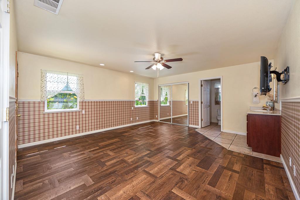 6181 Lambert Lane El Dorado, CA 95623 - Photo 49 of 80 a view of a livingroom with wooden floor and a ceiling fan