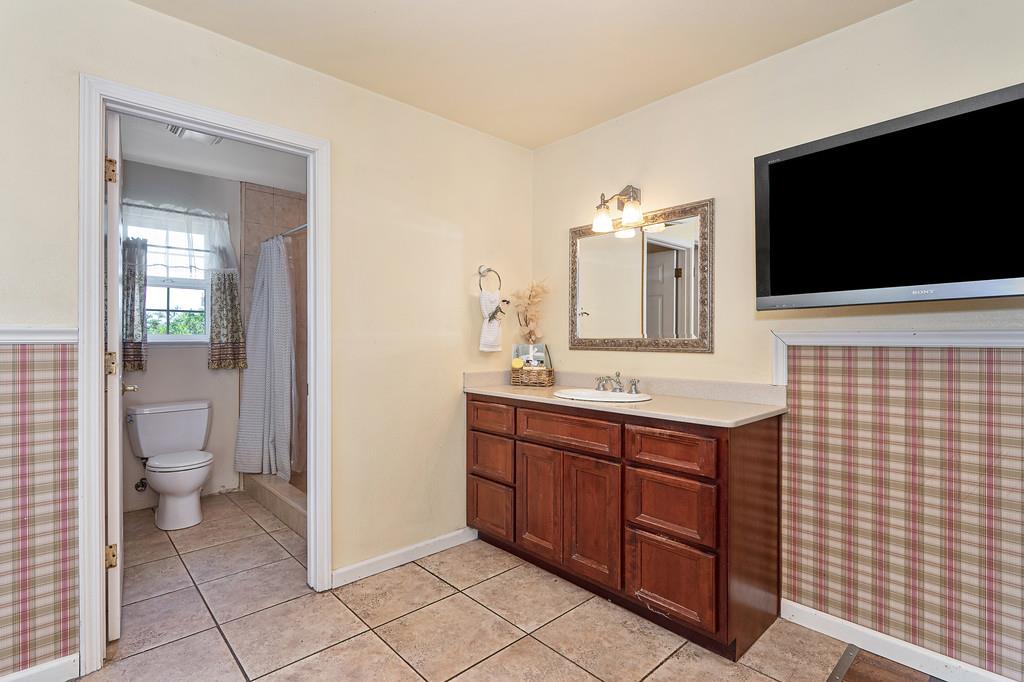 6181 Lambert Lane El Dorado, CA 95623 - Photo 54 of 80 a spacious bathroom with a double vanity sink a toilet and a mirror