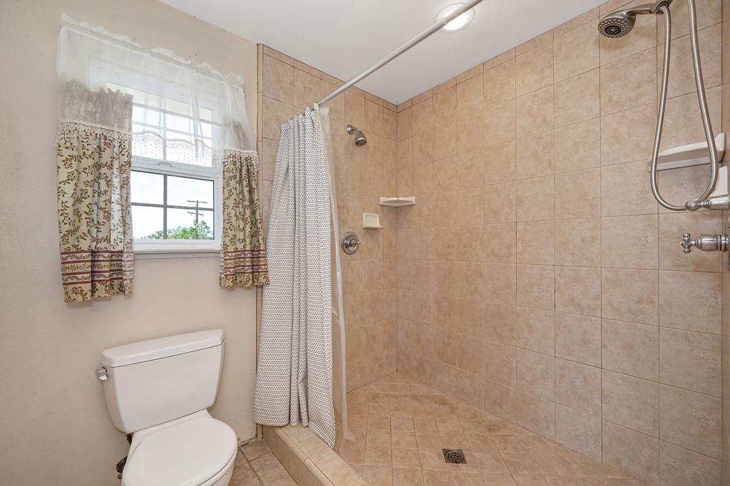 6181 Lambert Lane El Dorado, CA 95623 - Photo 55 of 80 a bathroom with a toilet a sink a shower and a mirror
