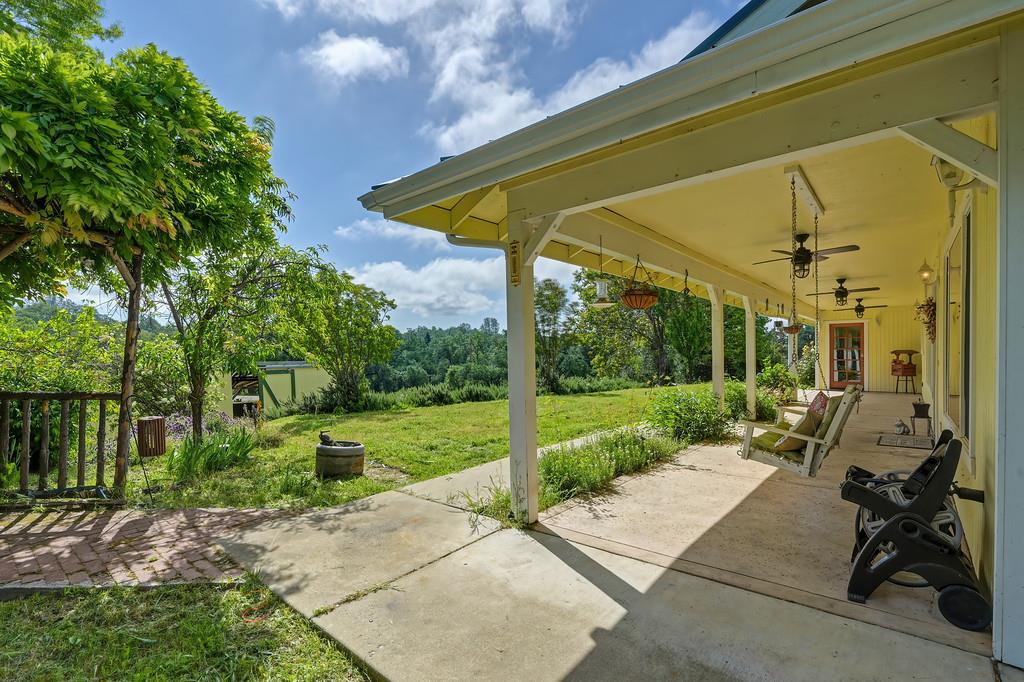 6181 Lambert Lane El Dorado, CA 95623 - Photo 73 of 80 a view of a patio with table and chairs under an umbrella