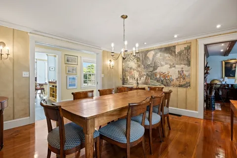 a view of a dining room and livingroom with furniture window and wooden floor