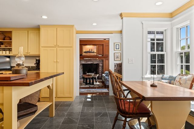 a kitchen with a table chairs sink and cabinets