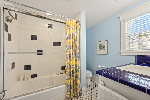 a bathroom with a bathtub and a shower