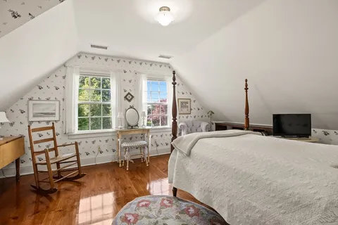 a bedroom with furniture and a large window