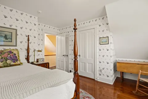 a bedroom with a bed and a chair in it