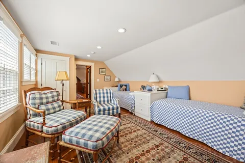 a bedroom with furniture and wooden floor