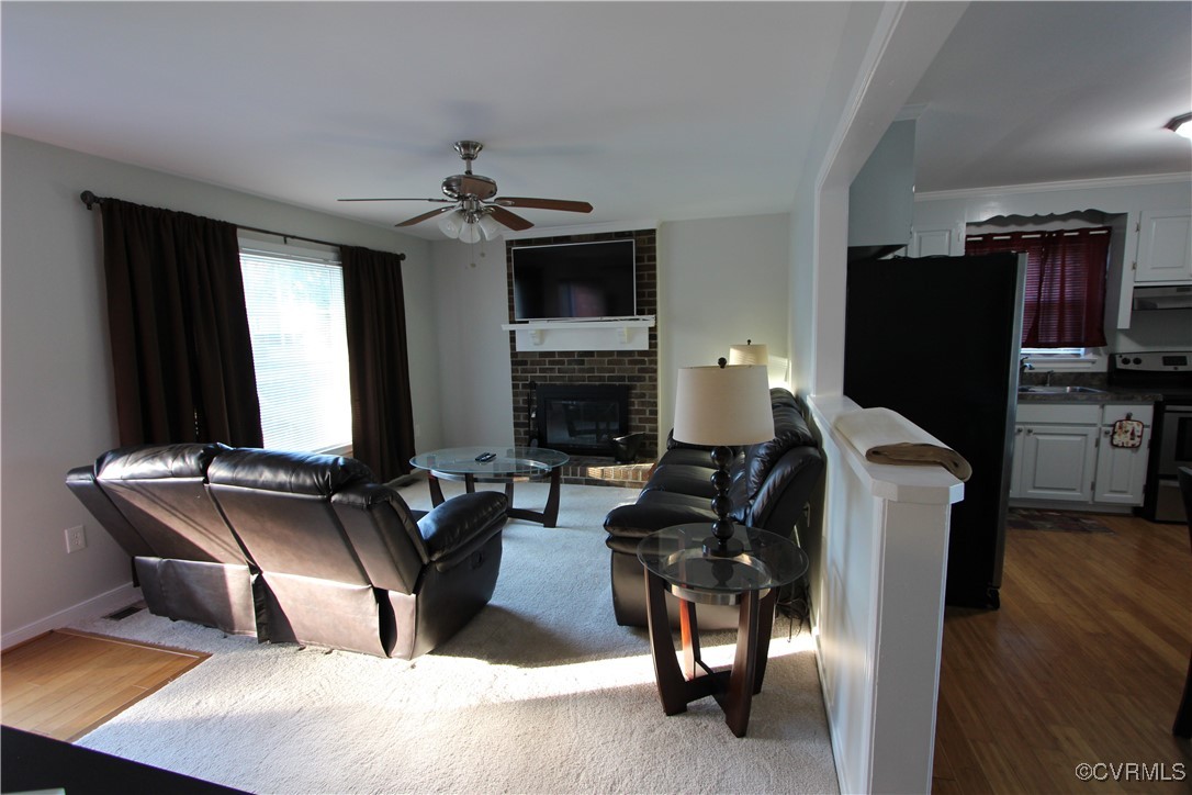 4849 Wilconna Road Chesterfield, VA 23832 - Photo 2 of 8 a living room with furniture a fireplace and a flat screen tv