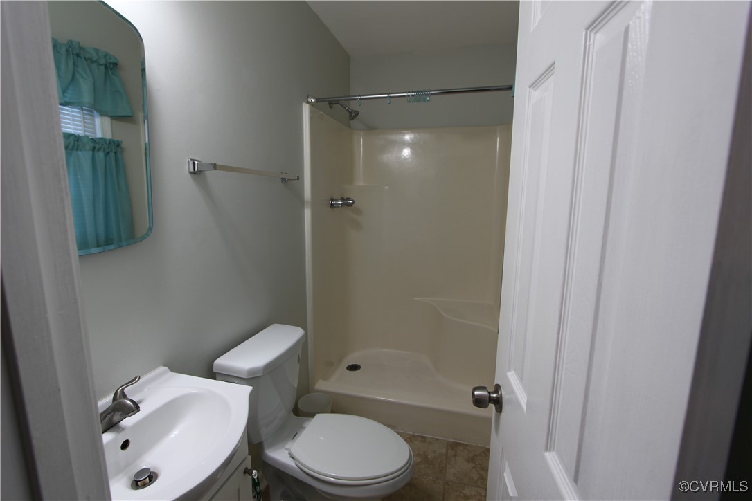 4849 Wilconna Road Chesterfield, VA 23832 - Photo 6 of 8 a toilet sitting next to a bathroom sink