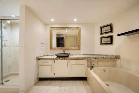 a bathroom with a bathtub sink and mirror