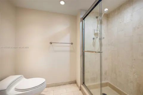 a bathroom with a shower and a toilet