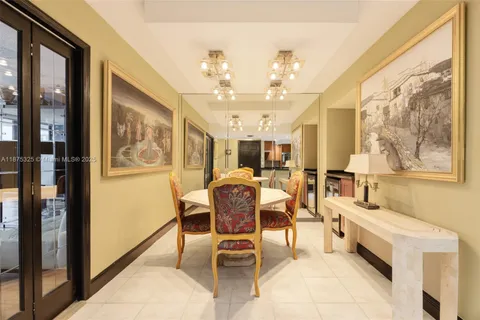 a dining room with wooden floor and furniture