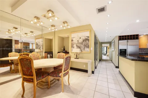a large kitchen with a table and chairs