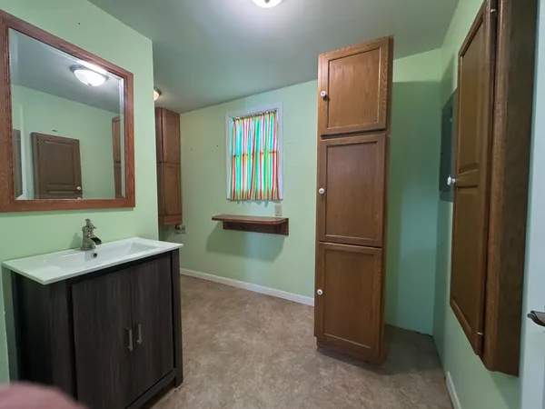 a kitchen with a refrigerator and a sink