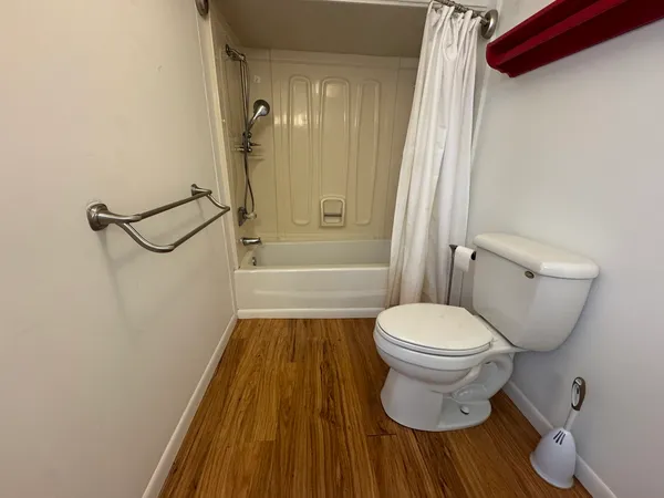 a bathroom with a shower a toilet and a sink