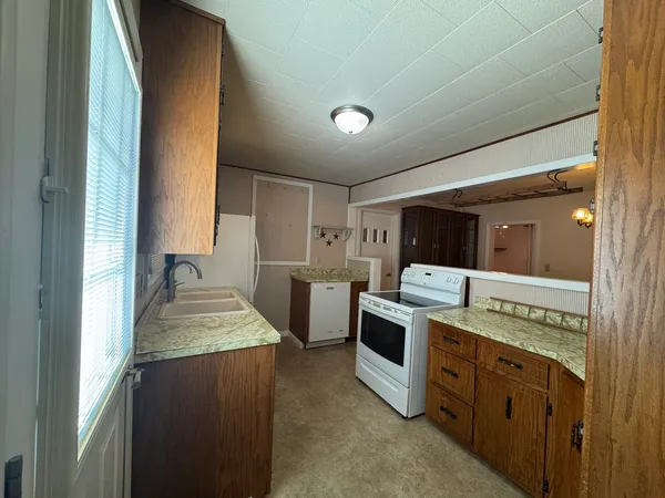 a kitchen with a stove and a refrigerator