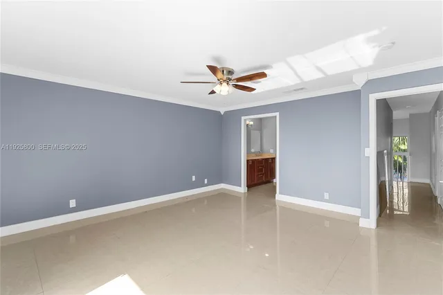 an empty room with closet and a ceiling fan