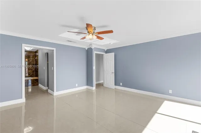 an empty room with closet and a chandelier fan