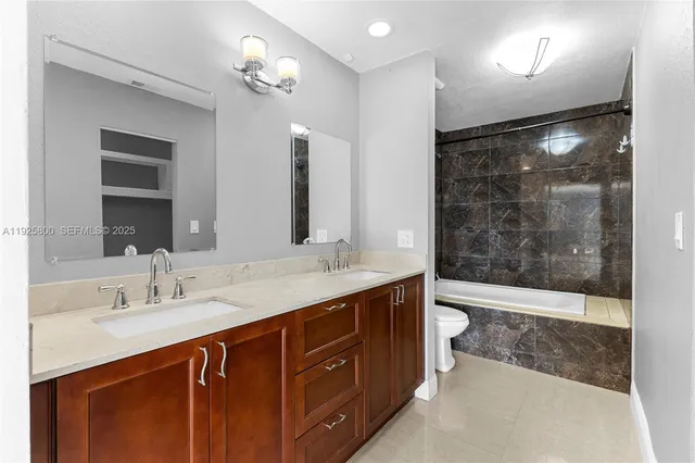 a bathroom with a double vanity sink mirror and shower