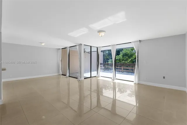 a view of an empty room with glass door