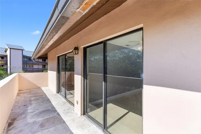 a balcony with chairs and a table