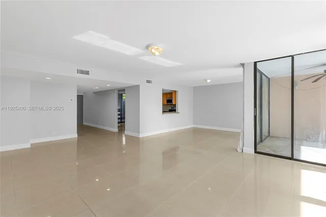 an empty room with a empty space and windows