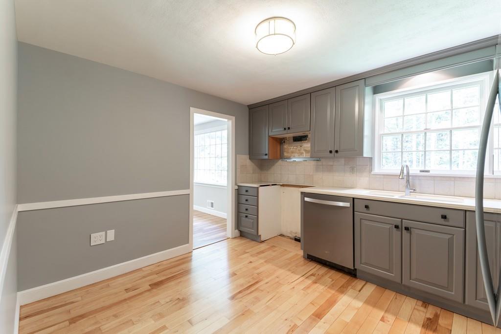 175 Powers Road Sudbury, MA 01776 - Photo 13 of 32 a kitchen with a sink cabinets and window